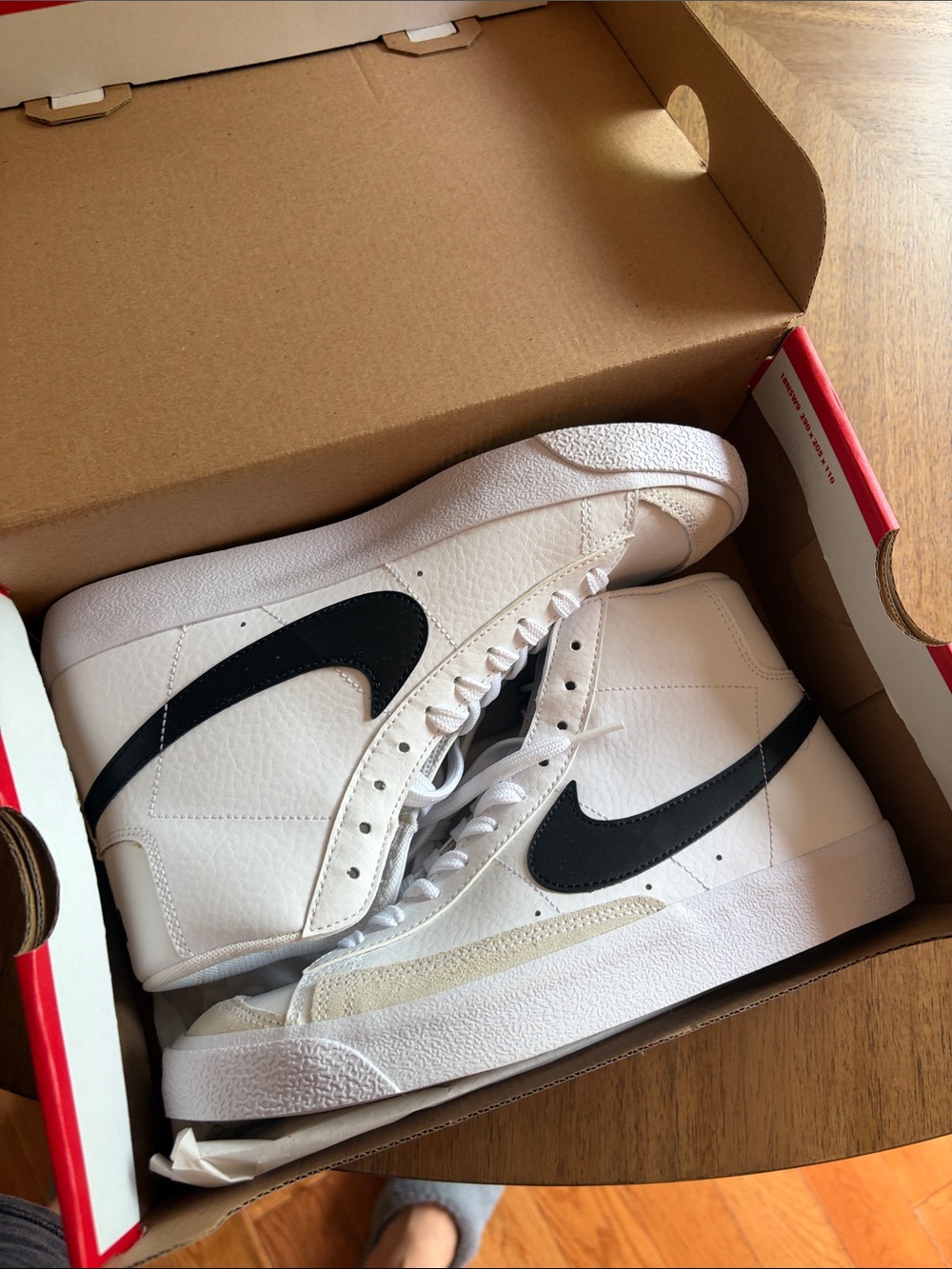 Nike White Mid-Top Sneakers with Black Swoosh